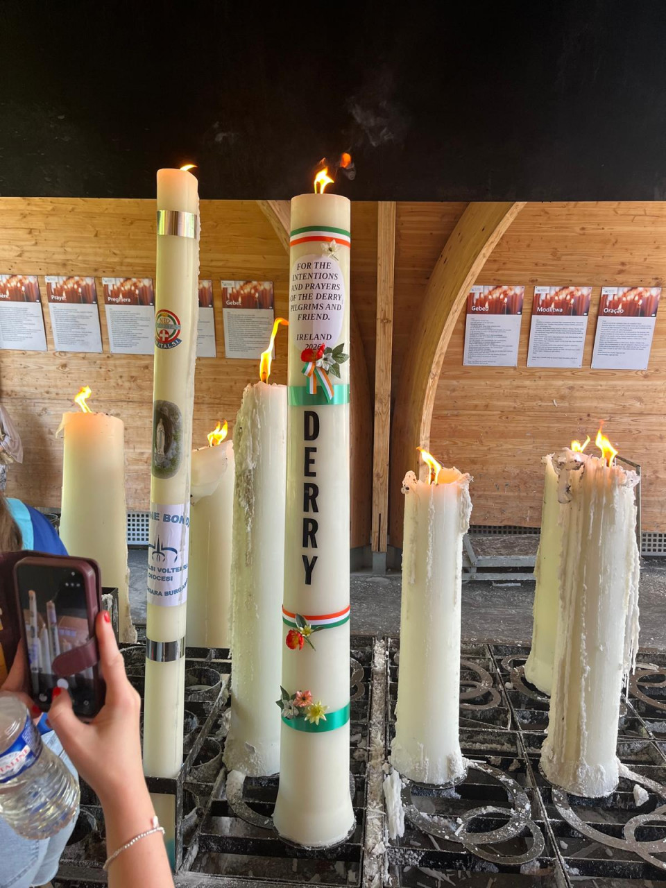The Derry Diocesan pilgrimage candle burning in Lourdes during the 2026 pilgrimage, representing the prayers and intentions of pilgrims and their families.